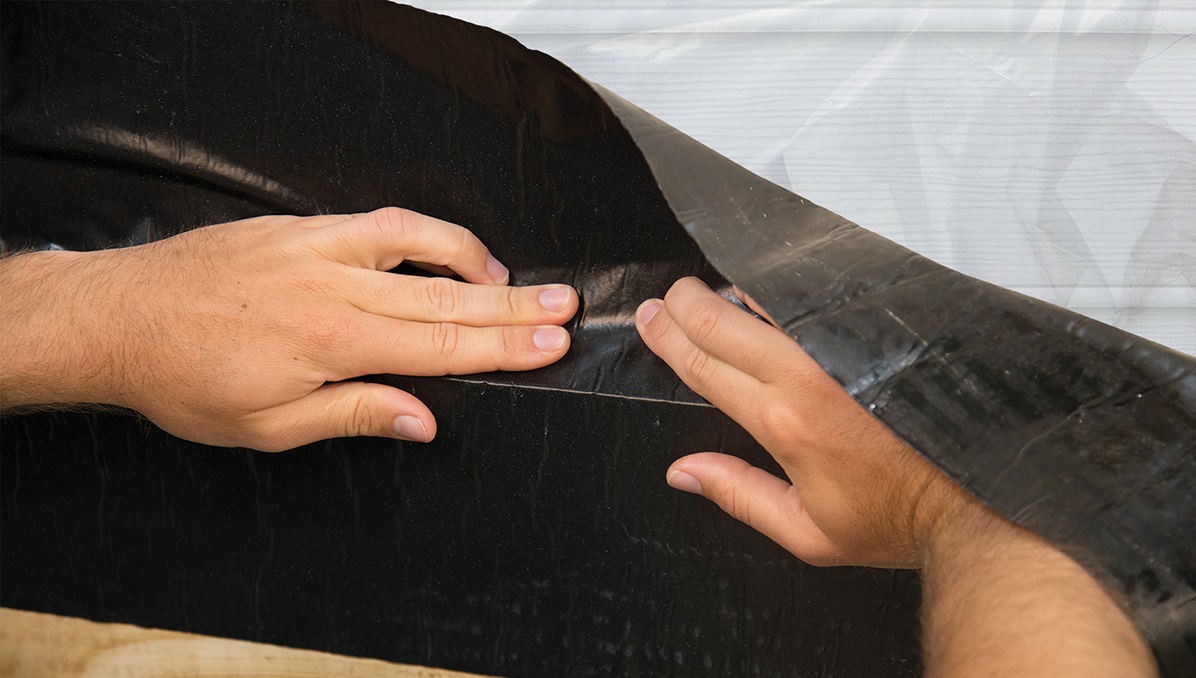 Ledger tape being installed on a ledger board